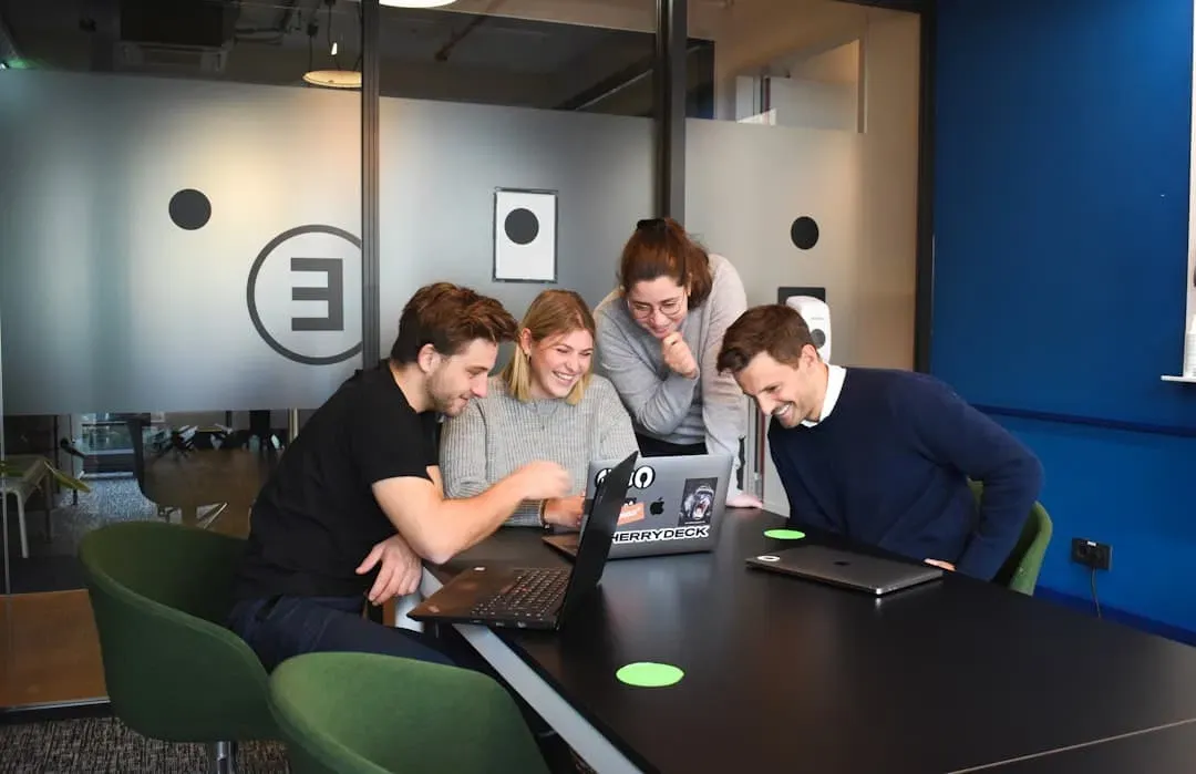 A diverse team collaborating around a table in a modern office